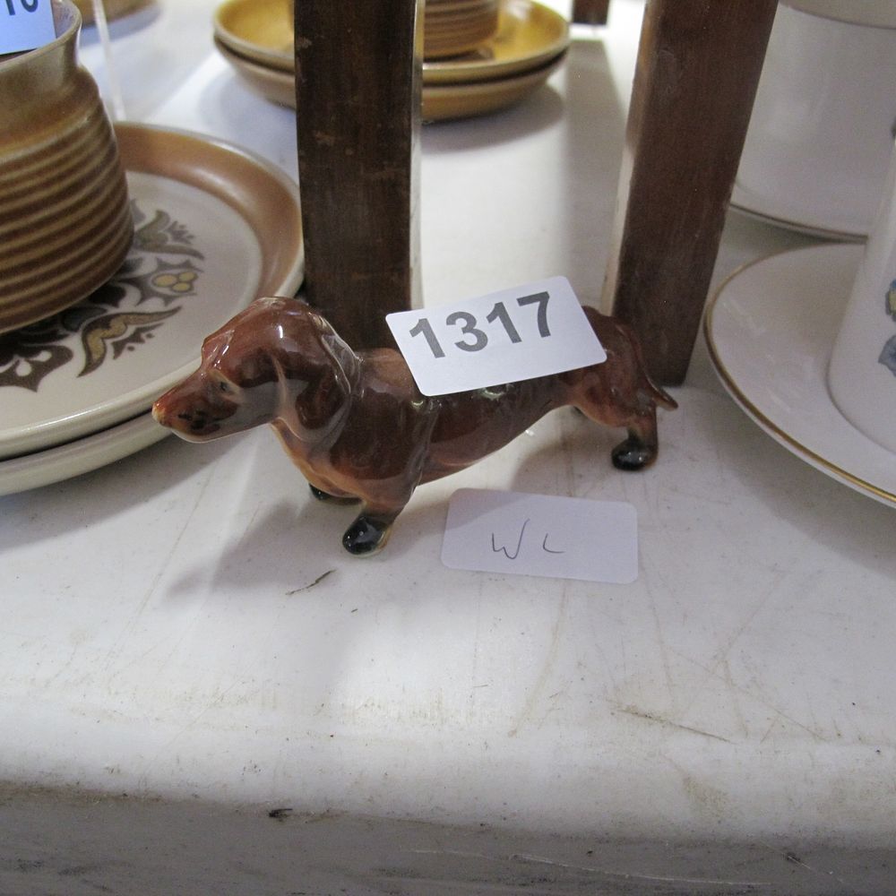 Lot 1317: A small ceramic sausage dog