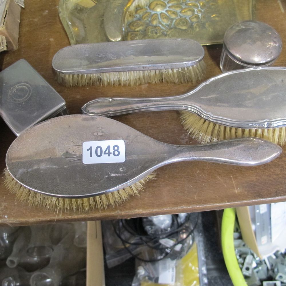 Lot 1048: Stamped silver dressing table clothing and hair brush...