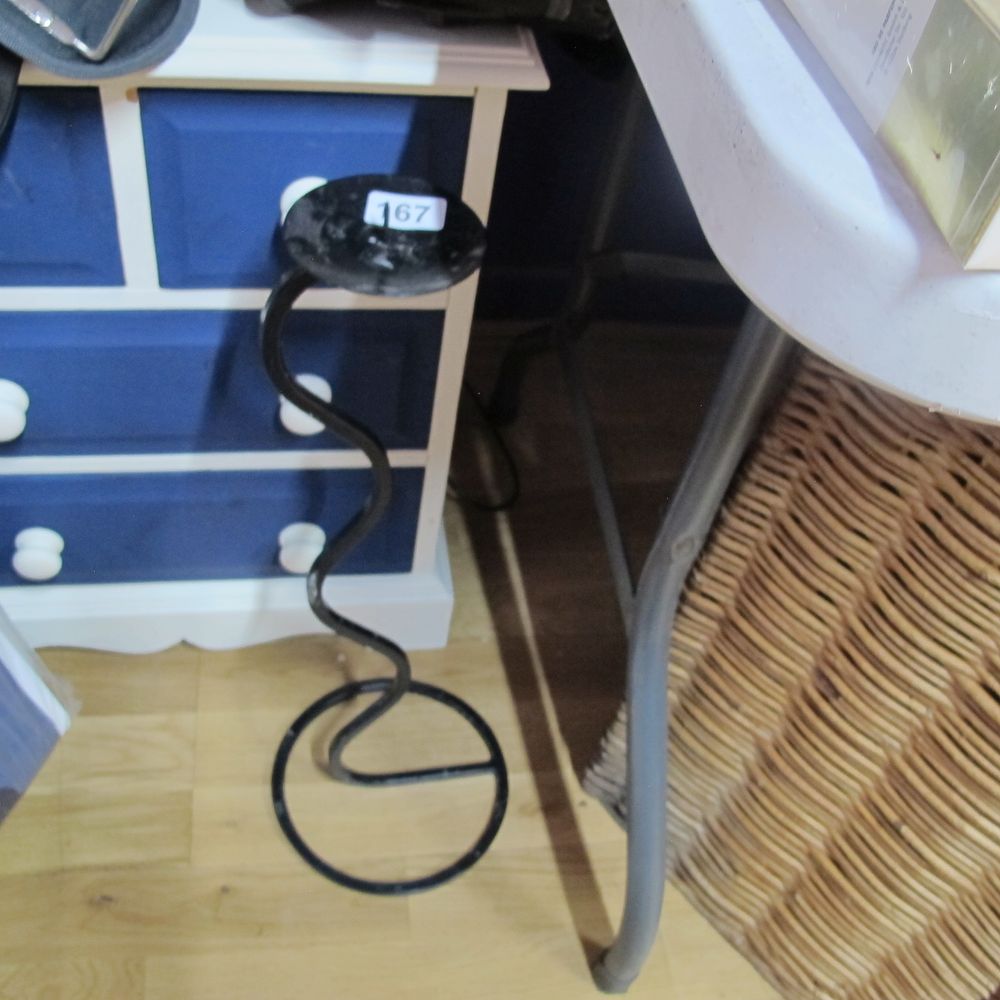 Lot 167: unusual iron candle stick holder