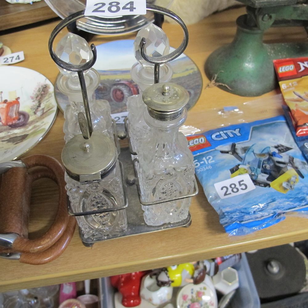 Lot 284: Cut glass crystal cruet set in stand