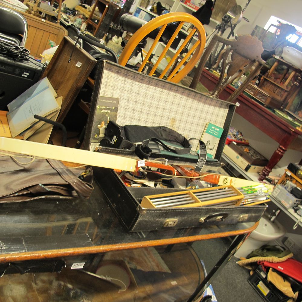 Lot 1025: A case of archery equipment with bow and...