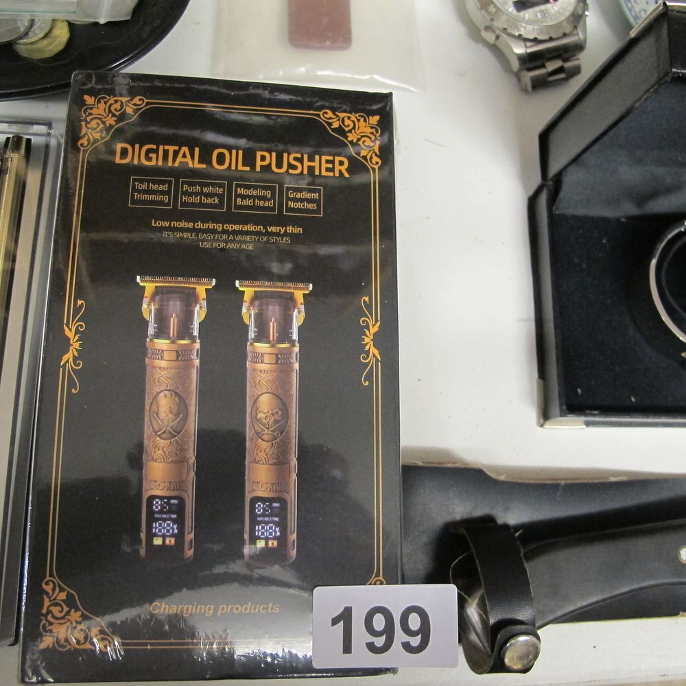Lot 199: Digital oil pusher zero gap LCD hair trimmer,...