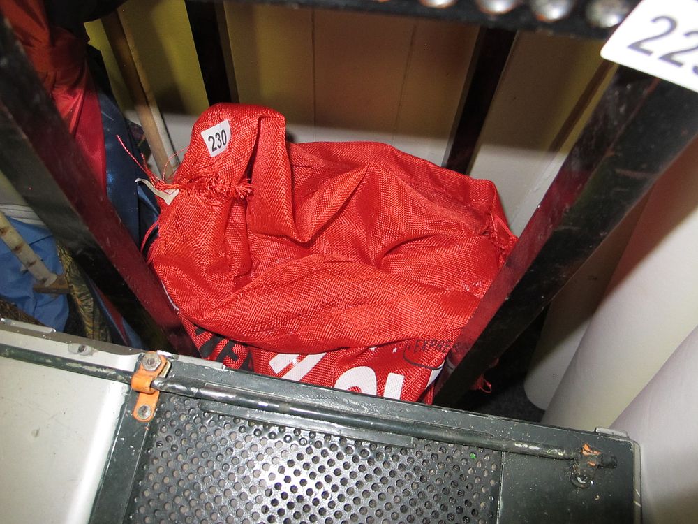 Lot 230: A Large Red Synthetic Woven Fabric Bag or...