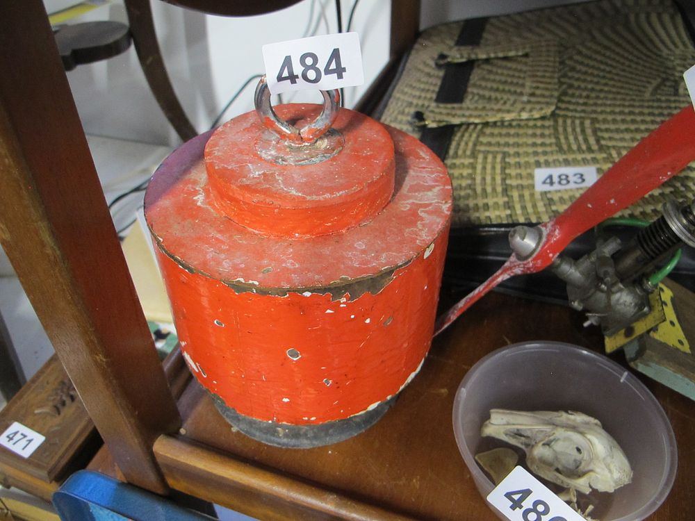Lot 484: A Heavily Weathered Red-Painted Metal Weight