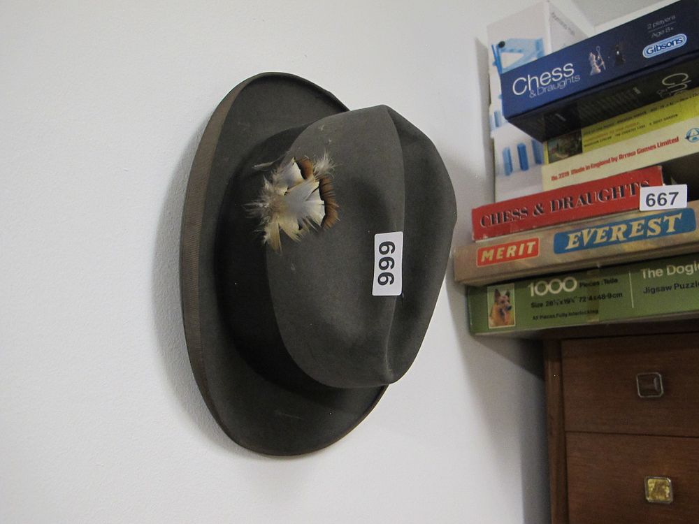 Lot 666: An Olive-Green Felt Hat with Feather Adornment