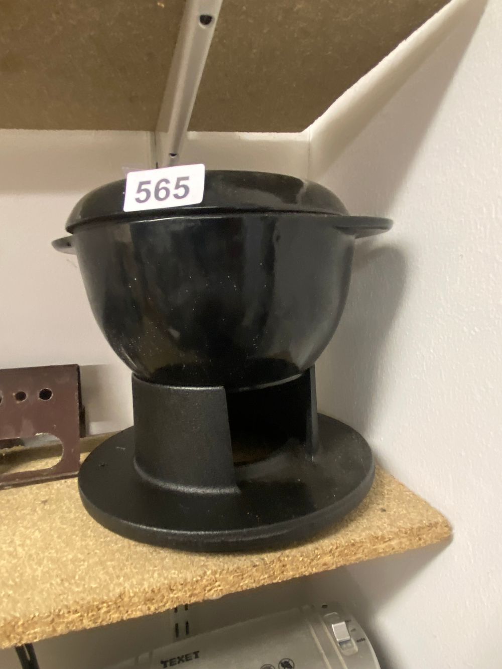 Lot 565: A Cast Iron Lidded Pot with Integrated Stand