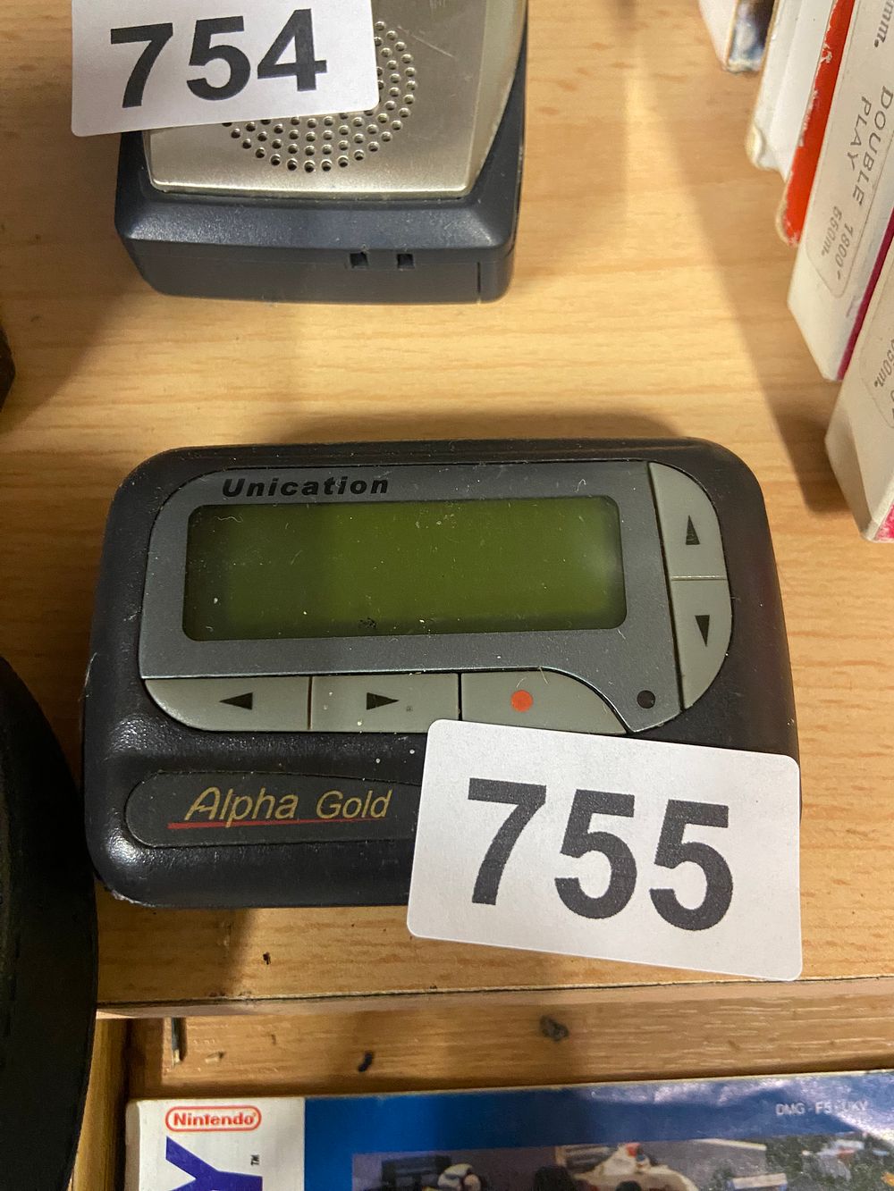 Lot 755: Unication Alpha Gold Alphanumeric Pager