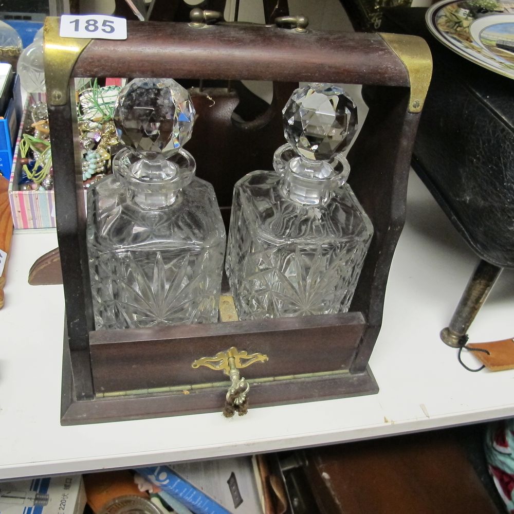 Lot 185: An Edwardian English Oak Tantalus with Two Cut...