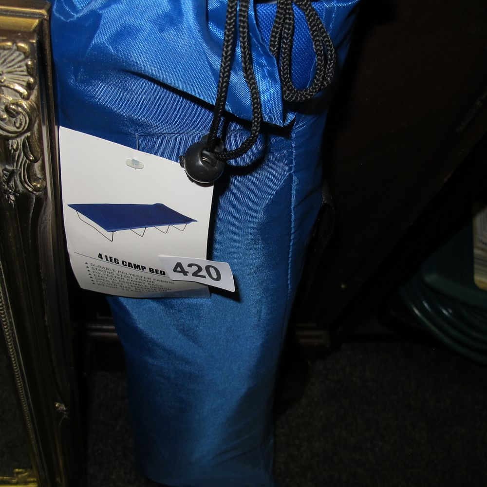 Lot 420: New or Unused 4 Leg Camp Bed in...