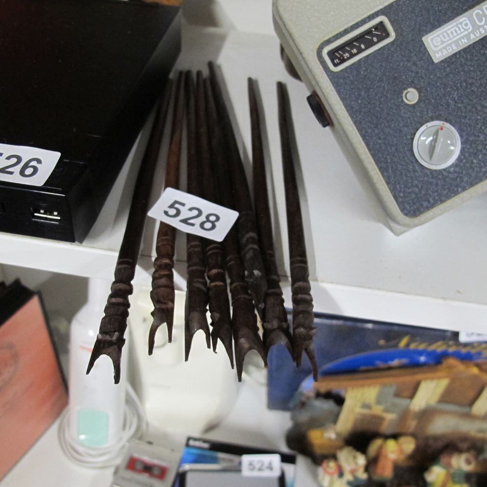 Lot 528: A Group of Carved Dark Wood Picks with...