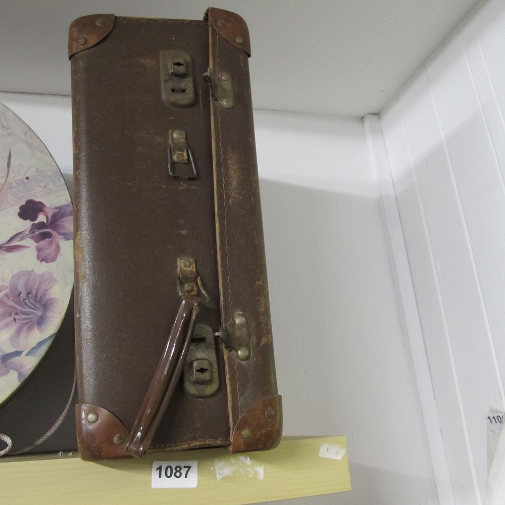 Lot 1087: A Mid-20th Century Vintage Dark Brown Leather Suitcase