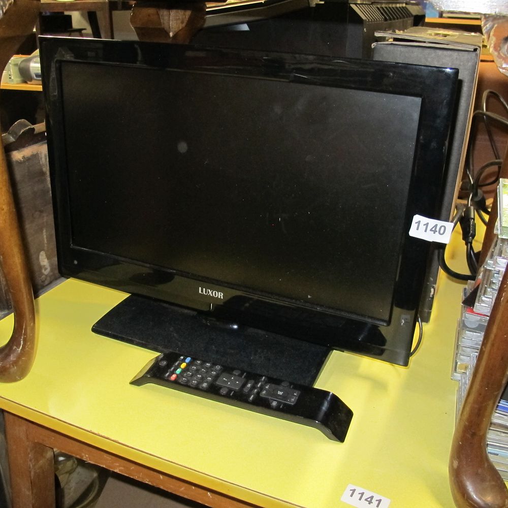 Lot 1140: A Modern LUXOR Flat-Screen Television with Remote Control