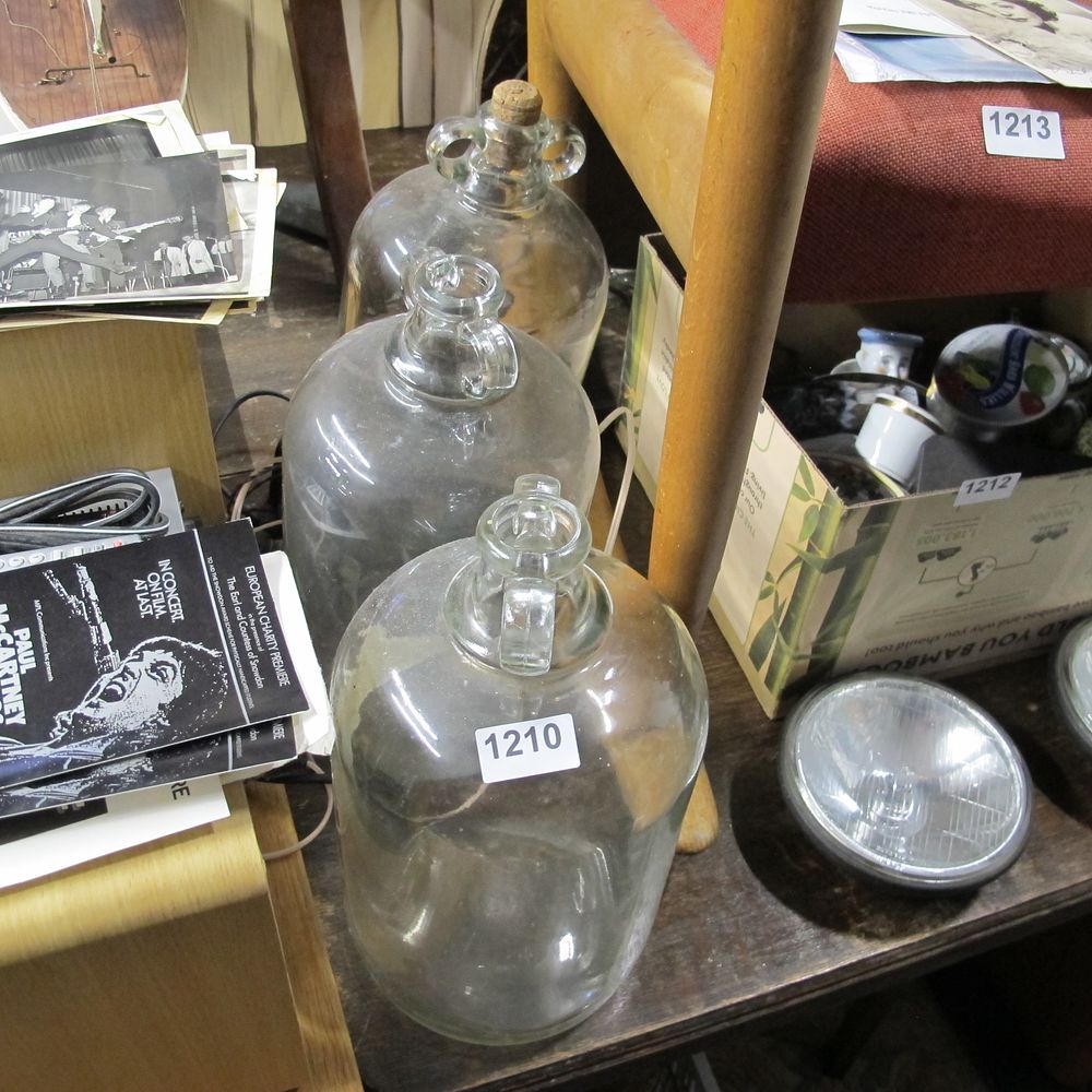 Lot 1210: three glass demijohn jars