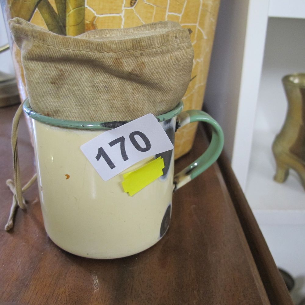 Lot 170: A Vintage Enamelware Mug with Fabric Pouch