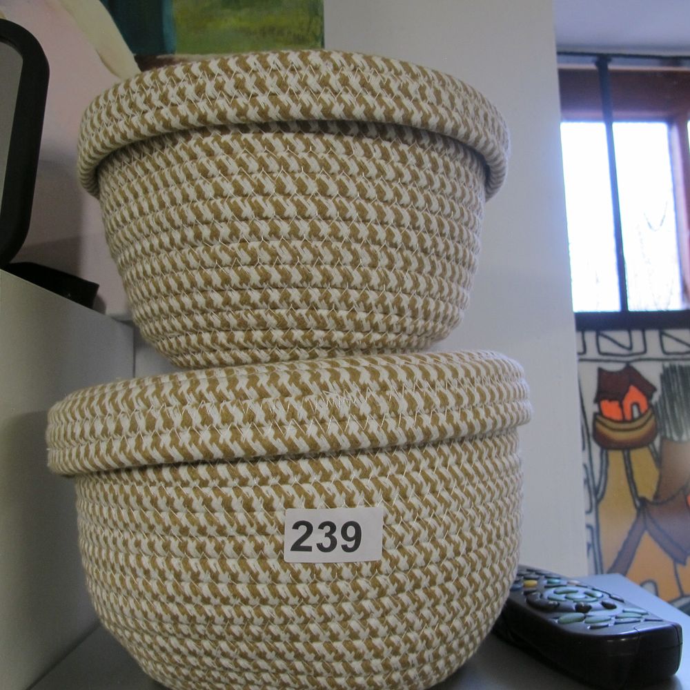 Lot 239: A Pair of Cotton Rope Woven Storage Baskets...