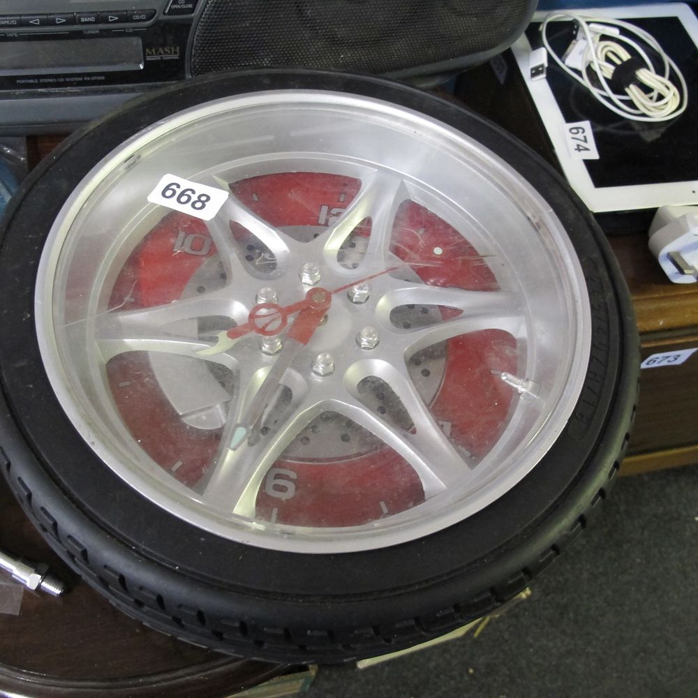 Lot 668: An Automotive Wheel and Tire Novelty Wall Clock