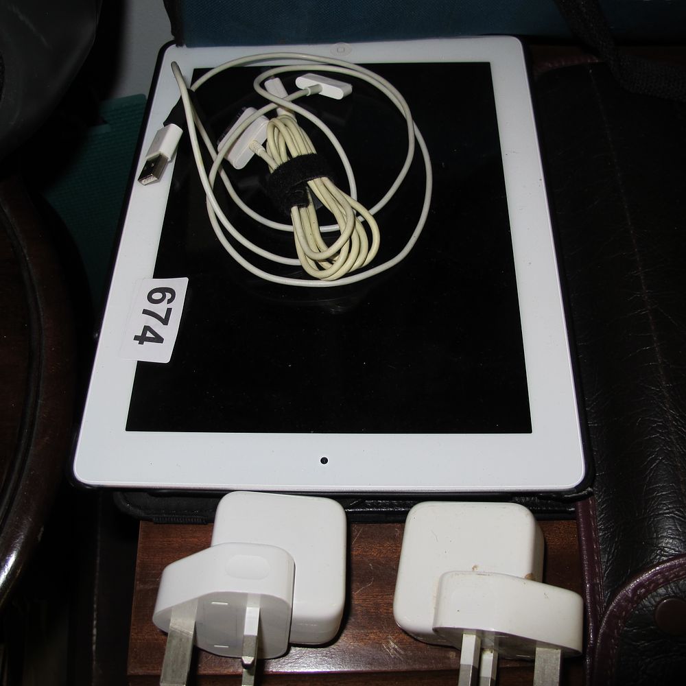 Lot 674: An Assortment of an Apple iPad and Charging...