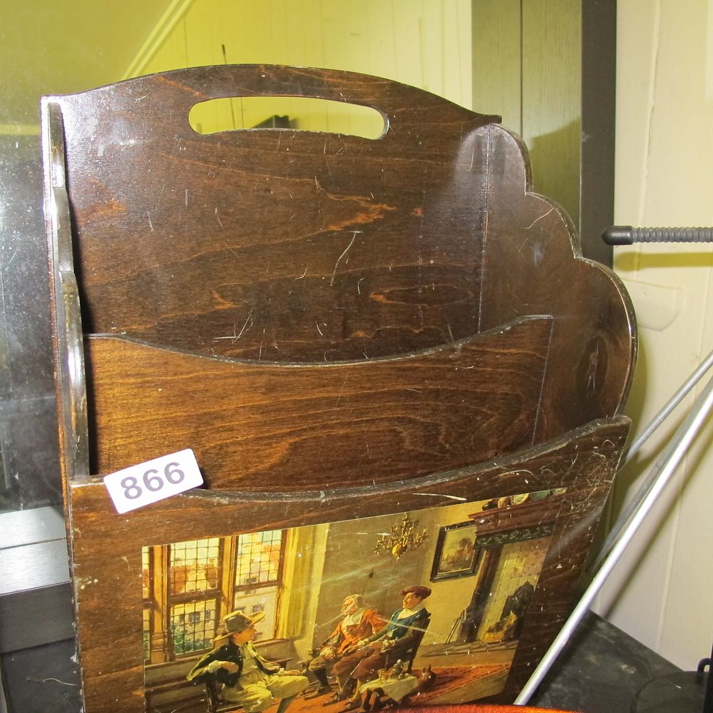 Lot 866: A Mid-Century Wooden Tiered Magazine Rack with Printed...
