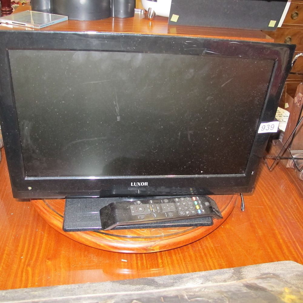 Lot 939: A Luxor flat-screen television with remote control and...