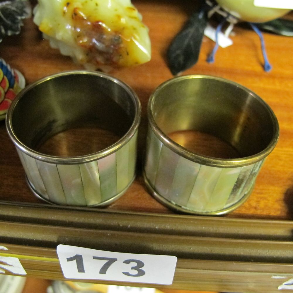 Lot 173: A Pair of Mother-of-Pearl Inset Brass-Toned Napkin Rings