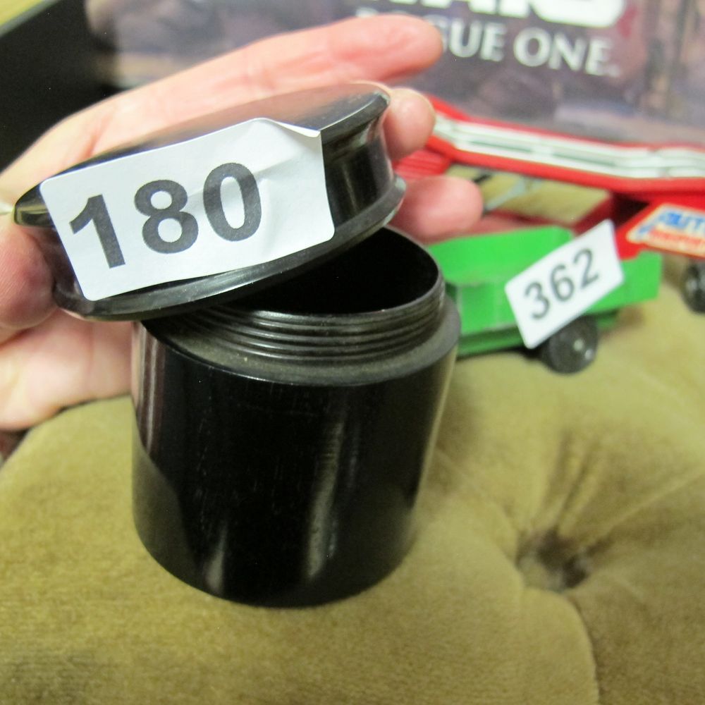Lot 180: A Small Black bakelite Cylindrical Container with Screw-on...