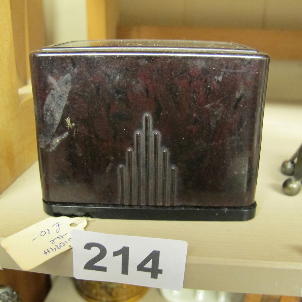 Lot 214: An Art Deco mottled maroon and black moulded...