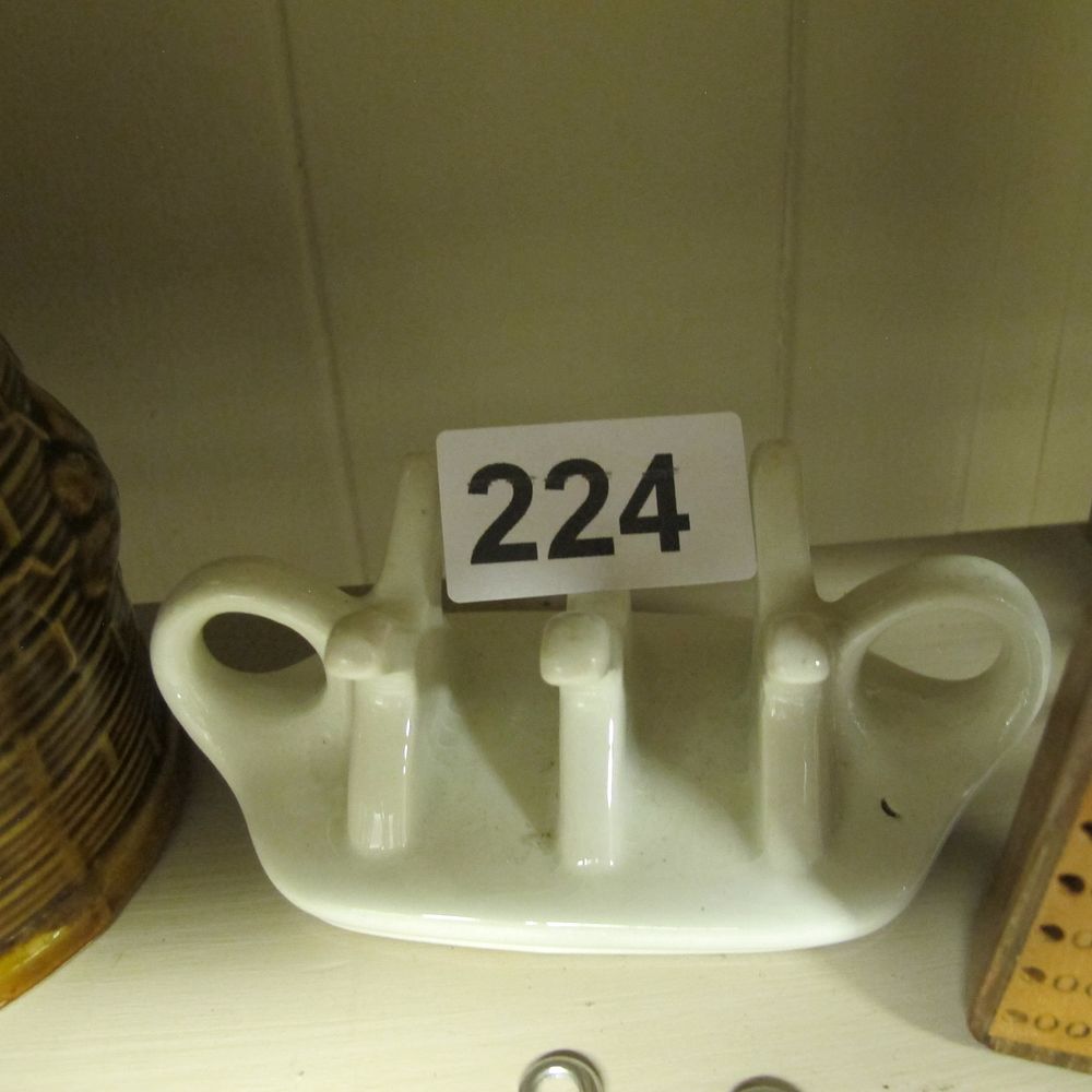 Lot 224: A 20th-century white glazed ceramic 2-slot toast rack