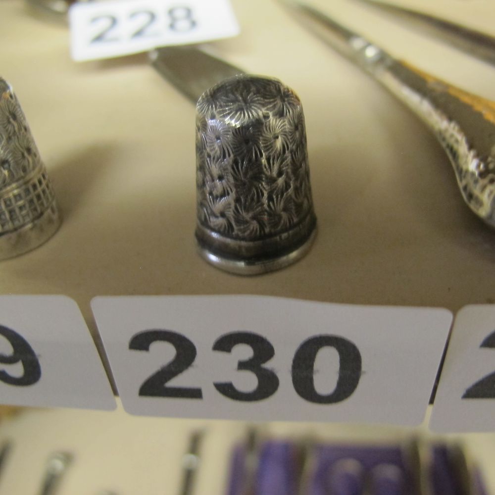 Lot 230: A Victorian silver thimble with starburst engraving