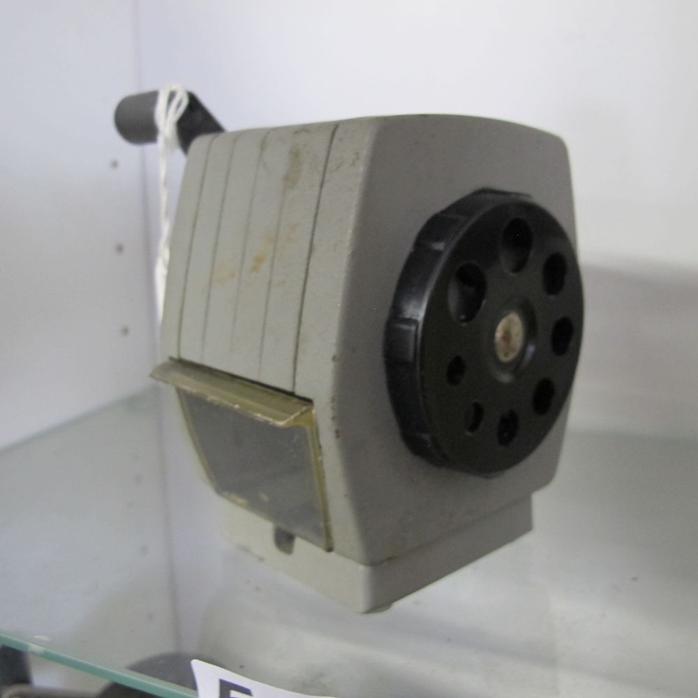 Lot 512: A vintage industrial manual crank-operated desktop pencil sharpener