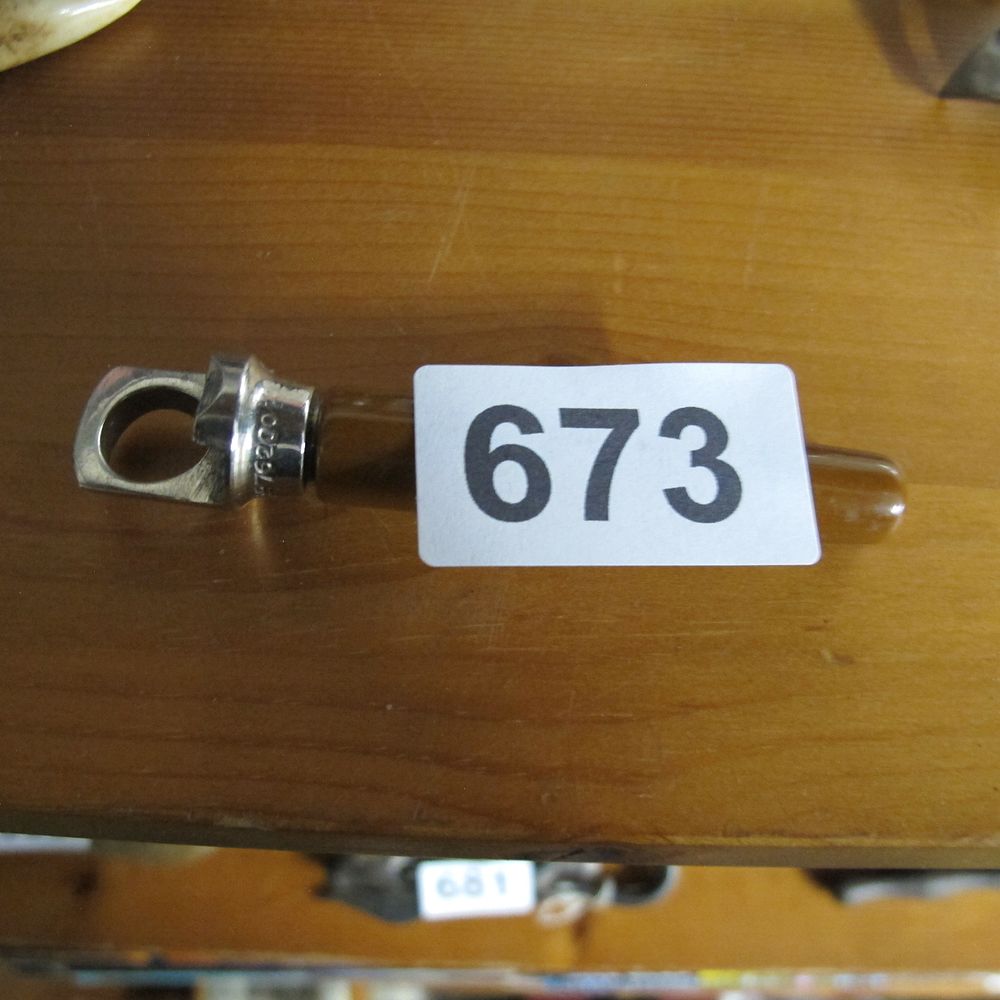 Lot 673: An early 20th century amber-coloured miniature accessory with...