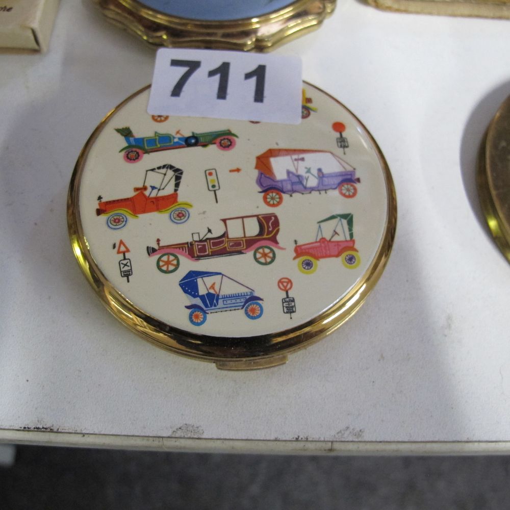 Lot 711: A 1950s Stratton powder compact with vintage car...
