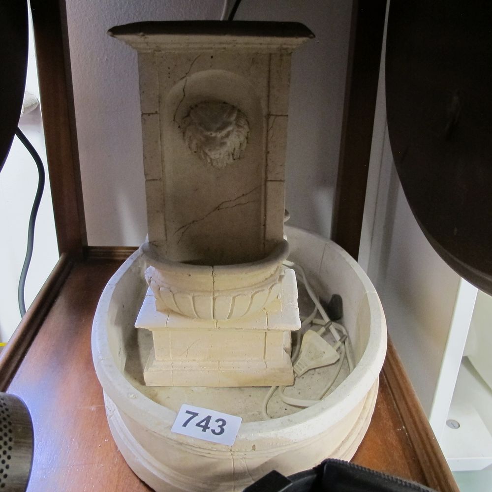 Lot 743: A modern cast composite table-top electric lion mask...