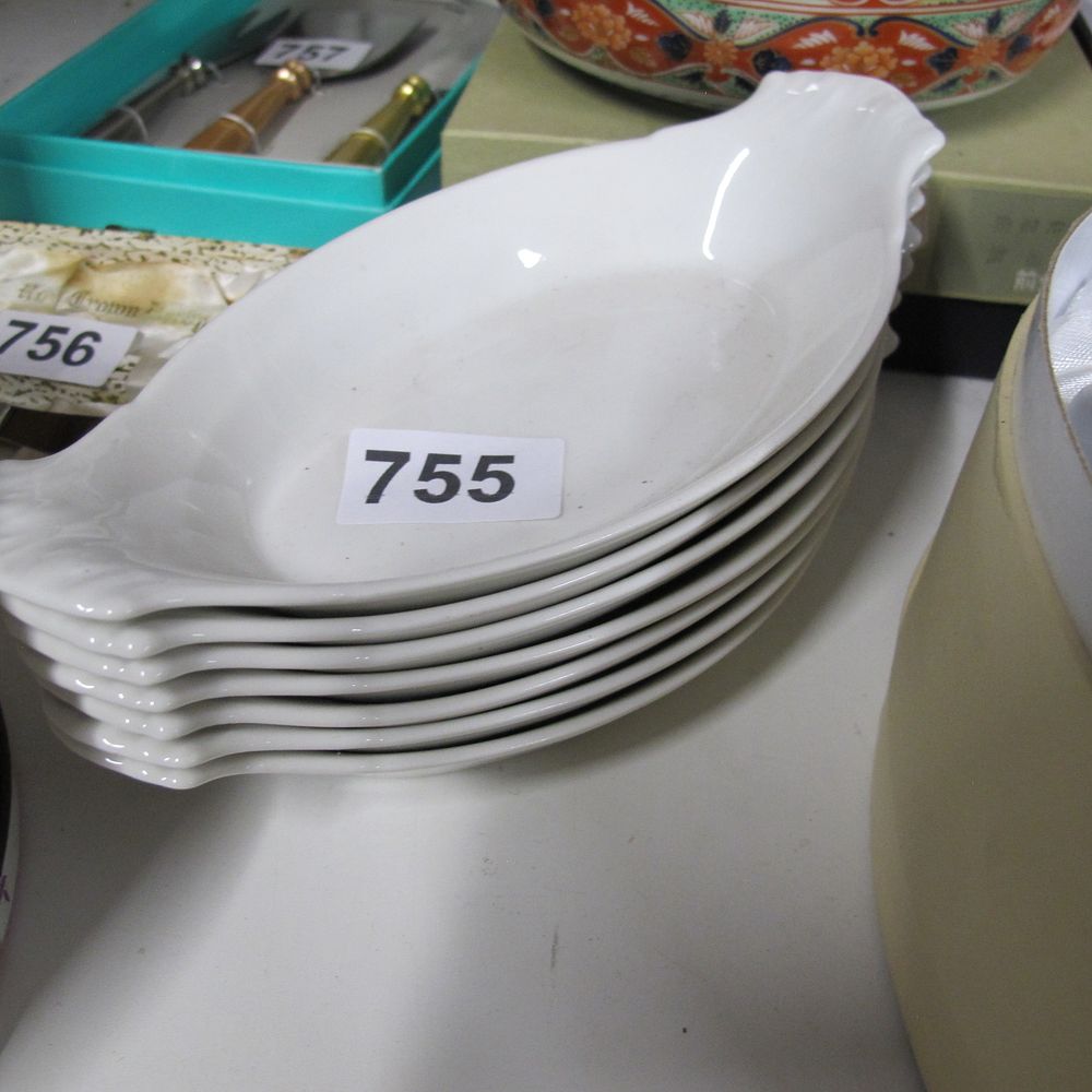Lot 755: A set of seven white porcelain individual oval...