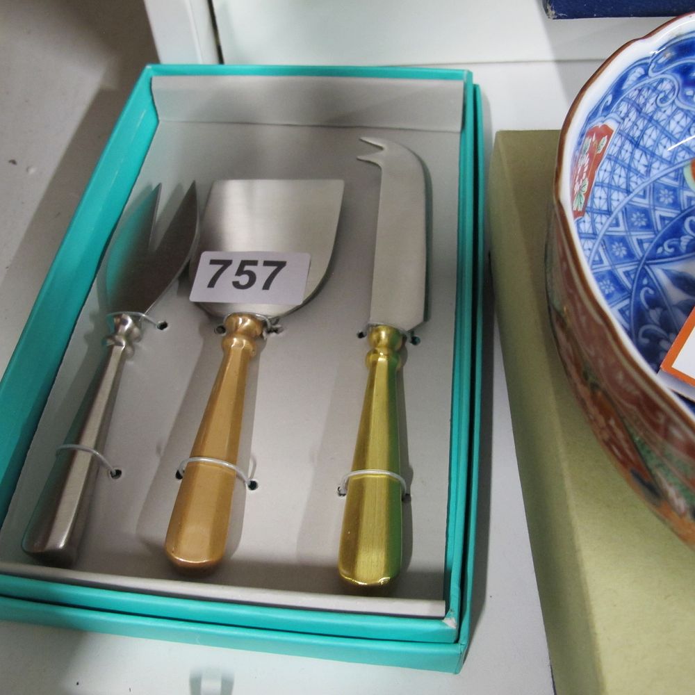 Lot 757: A three-piece Oliver Bonas stainless steel cheese service...