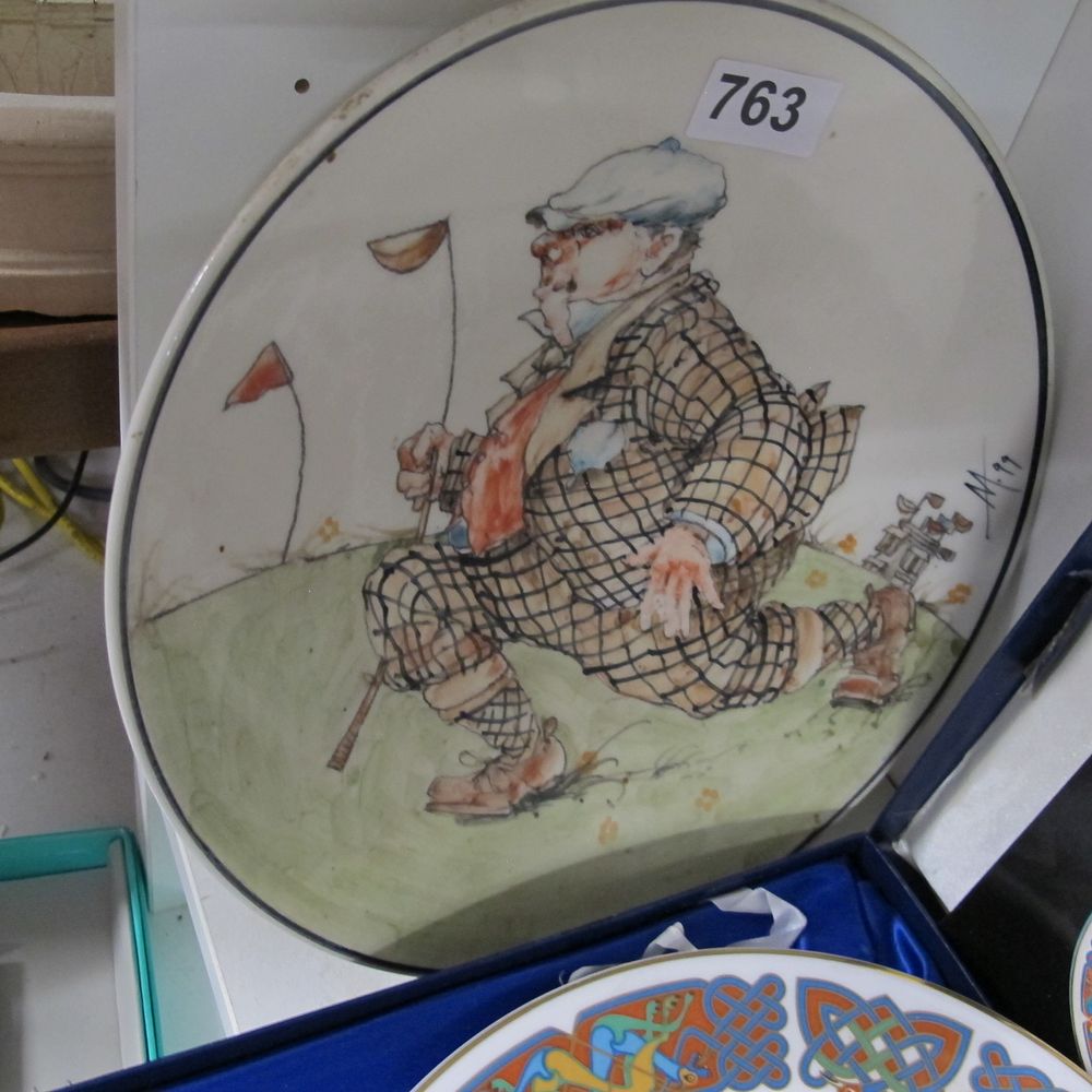 Lot 763: A studio-decorated earthenware charger featuring a satirical golfing...
