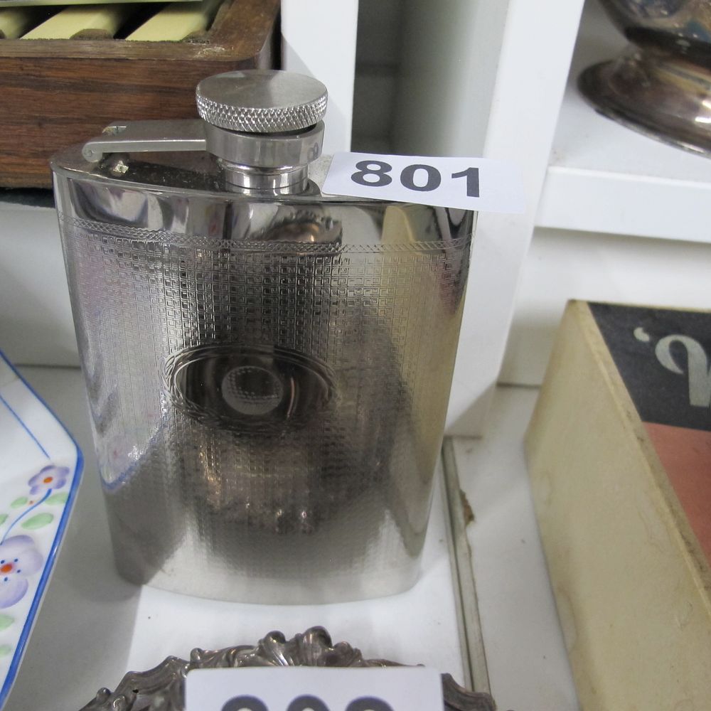 Lot 801: A Polished Metal Hip Flask with Engine-Turned Basket...