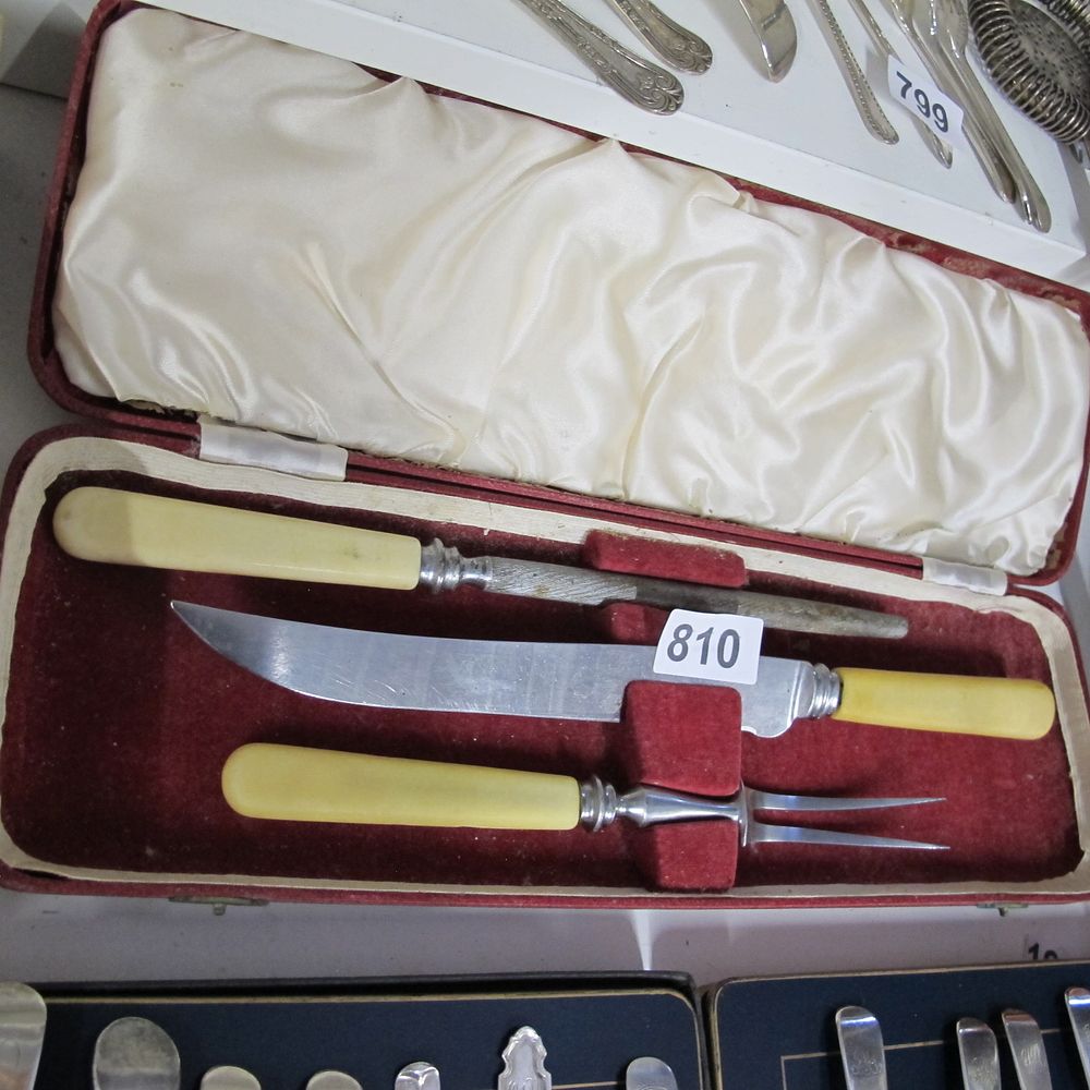 Lot 810: A three-piece carving set with cream-coloured handles in...