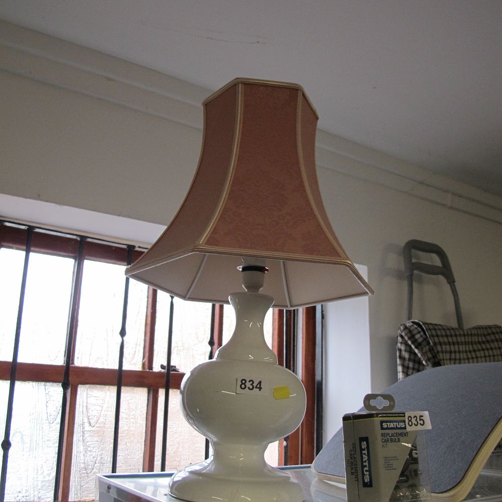 Lot 834: A glazed white ceramic table lamp with a...