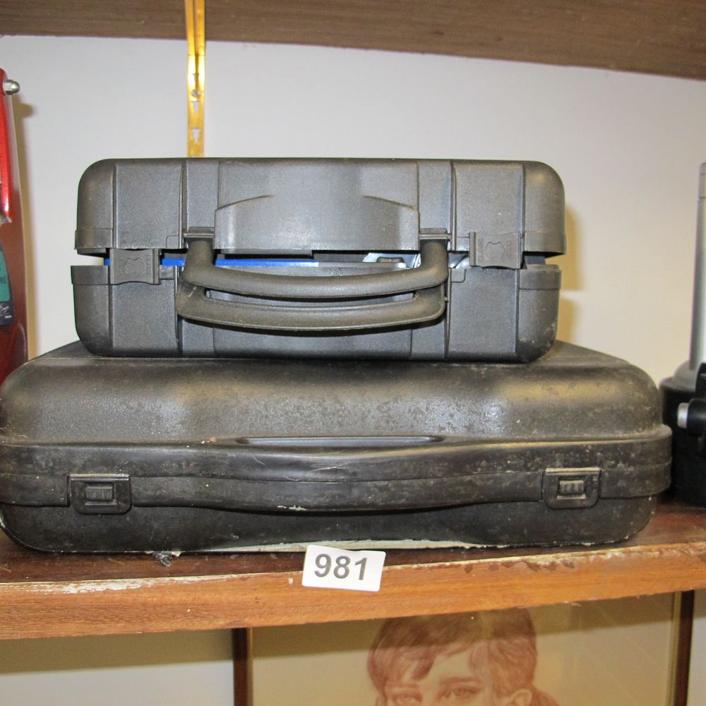 Lot 981: Two black blow-moulded plastic hard-shell carrying cases