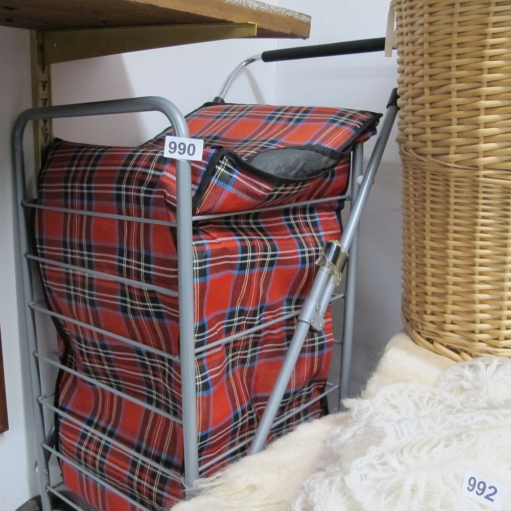 Lot 990: A two-wheeled shopping trolley with red tartan textile...