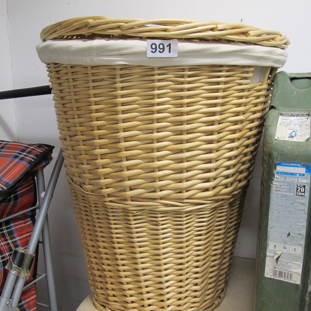 Lot 991: Two items comprising a woven wicker laundry basket...