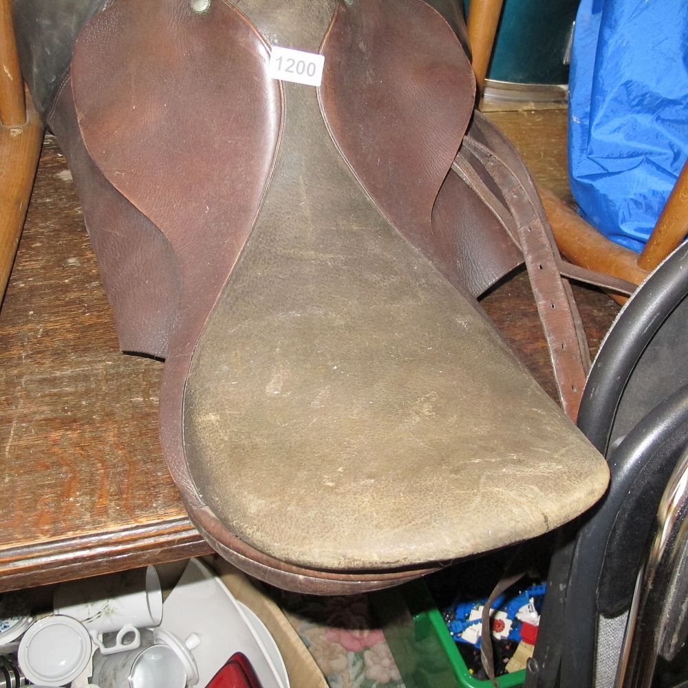 Lot 1200: A Vintage English Leather Horse Saddle with Stirrup...