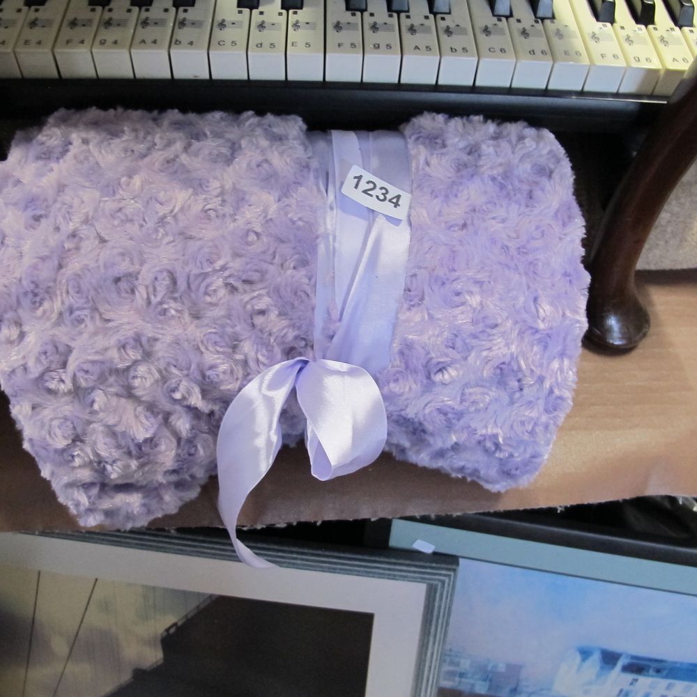 Lot 1234: A contemporary lavender-coloured synthetic fleece throw in the...