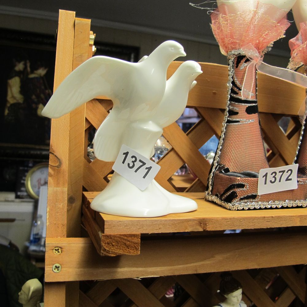 Lot 1371: A white glazed porcelain figurine of two doves,...
