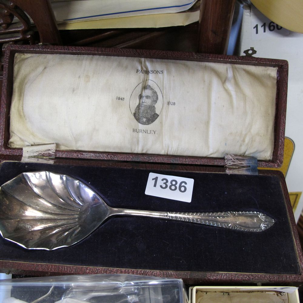 Lot 1386: A Cased Commemorative Silver-Plated Shell-Form Preserve Spoon for...