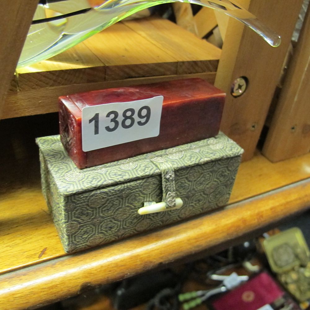 Lot 1389: A Chinese Carved Red Hardstone Seal with Silk-Covered...