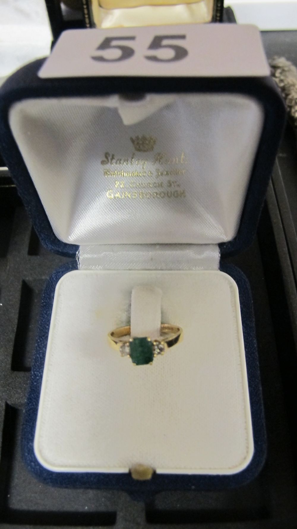 Lot 55: Yellow Metal Green Gemstone and Diamond Trilogy Ring in Fitted Retailer Case