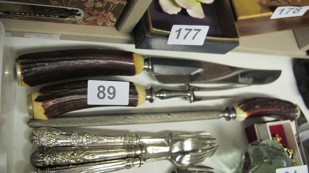 Lot 89: A Three-Piece Stag-Handled Carving Set and a Collection of Silver-Plated Flatware