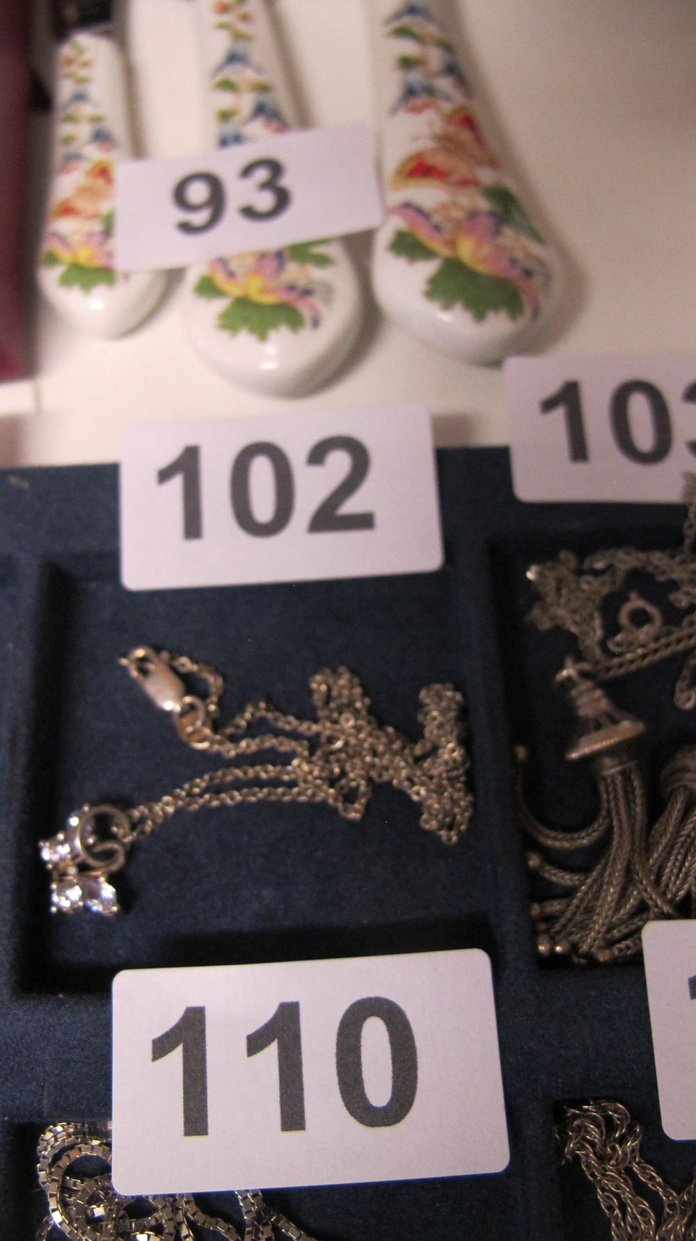 Lot 102: A Group of Silver Toned Jewellery and Three Ceramic Handled Spreaders