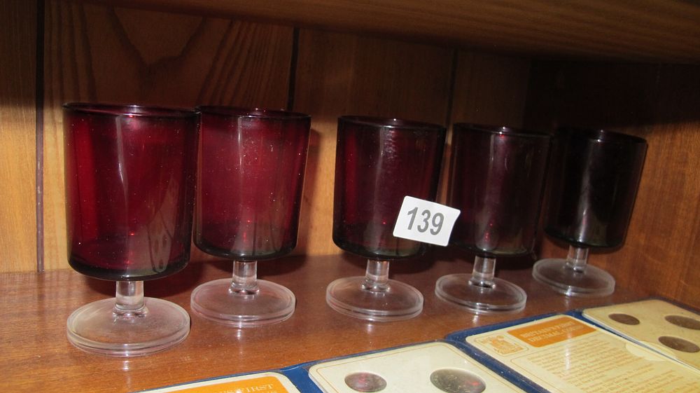 Lot 139: A Set of Five Luminarc Cavalier Ruby Red Glass Sherry Glasses